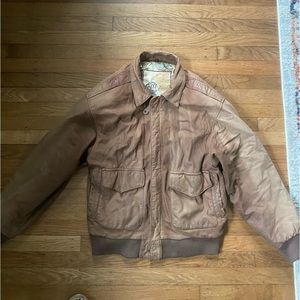 Vintage tan leather bomber jacket. Very worn and faded.